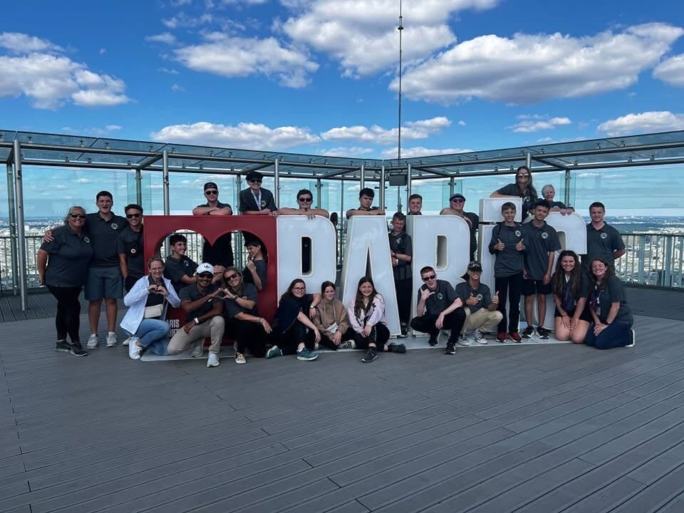 Cadets and chaperones gathered at a rooftop city overlook during the squadron trip to France