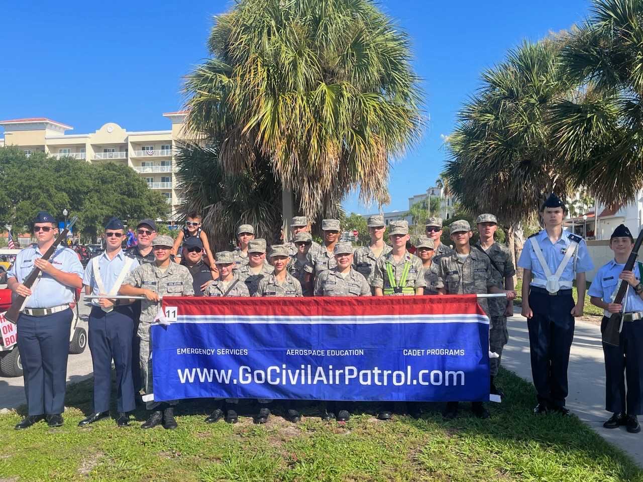 The Clearwater Composite Squadron gathered behind a Civil Air Patrol banner at a Florida community event